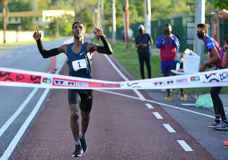 CHAMPION: Kelvin Johnson crosses the finish line on the bicycle path in Chaguaramas, yesterday, to win the Trinidad and Tobago International Marathon (TTIM) 40th Edition title. The Guyanese-born runner returned a time of two hours, 55 minutes and 33 seconds.  —Photo: ISHMAEL SALANDY
