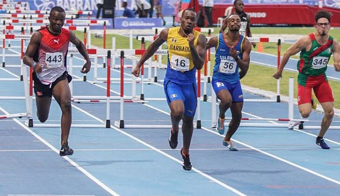 Bajan Shane Brathwaite, second from lleft, takes gold in the CAC 110m hurdles yesterday ahead of TT's Ruebin Walters, left, in Colombia.