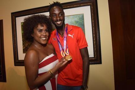 EREEM AND HIS LADY: File photo from August 16 2017 shows national sprinter Jereem Richards displaying his IAAF World Championship medals with his girlfriend Kayja Thomson, at the VIP Lounge, Piarco International Airport.   —Photo: CURTIS CHASE