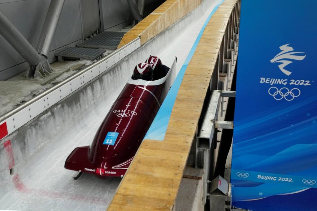 FINE-TUNING: Axel Brown and Andre Marcano of Trinidad and Tobago speed down the track during a two-man bobsleigh training run Saturday, at the 2022 Winter Olympics, in the Yanqing district of Beijing, China. —Photo: AP