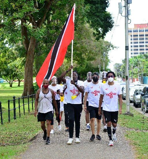 FAITHFUL WALKERS: Brian Lewis, Trinidad and Tobago Olympic Committee (TTOC) president, right, and supporters reach the Queen’s Park Savannah as part of the activity surrounding Sunday’s hosting of the 40th T&T International Marathon. Lewis and his group of 27 did the walk to raise funds for the committee’s Athlete Welfare and Preparation Fund to support athletes preparing for the Olympic Games. —Photo: ISHMAEL SALANDY