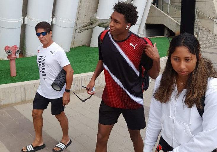 LANDED: Team TTO featuring from coach Maurice Faria, from left, Nikoli Blackman and Tyla Ho A Shu, on their way to the competition pool in Netanya, Israel, yesterday, ahead of the start  of the World Aquatics Junior Swimming Championships which splashes off today. --Photo: Bertram Blackman (Image obtained at trinidadexpress.com)