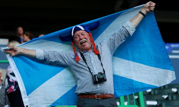 Barrie Schofield in the stands before the 2014 Commonwealth Games opening ceremony in Glasgow. Photograph: David Davies/PA Media (Image obtained at theguardian.com)