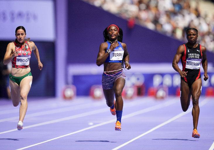 DEBUTANTE: Trinidad and Tobago’s Leah Bertrand, right, battles to the line in the sixth Olympic Games women’s 100 metres first round heat at the Stade de France, in Paris, yesterday. The Olympic debutante clocked 11.27 seconds to finish third, advancing automatically to today’s semifinal round. American Twanisha Terry, centre, won in 11.15. Mexico’s Cecilia Tamayo-Garza, left, was fifth in 11.39.  —Photo: AP (Image obtained at trinidadexpress.com)