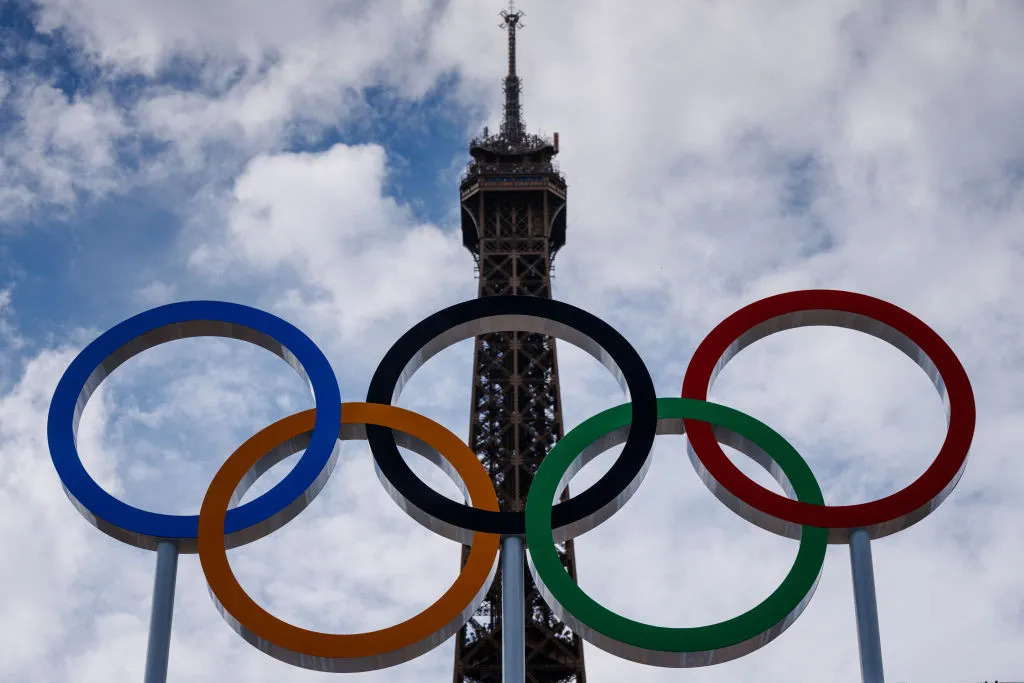 This photograph shows the Olympic Rings displayed at the construction site of the Eiffel Tower Stadium for the upcoming Paris 2024 Olympics and Paralympic Games which will host the Beach Volleyball and men's Blind Football competitions, at the Champ-De-Mars in Paris on July 10, 2024. DIMITAR DILKOFF/AFP— Getty Images (Image obtained at time.com)